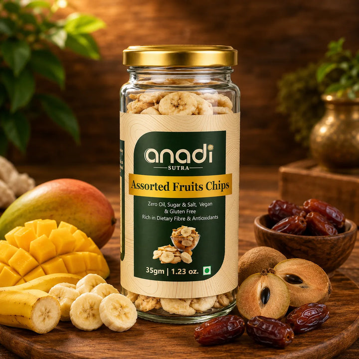 Assorted fruit chips jar with golden lid beside mango, banana, and dates
