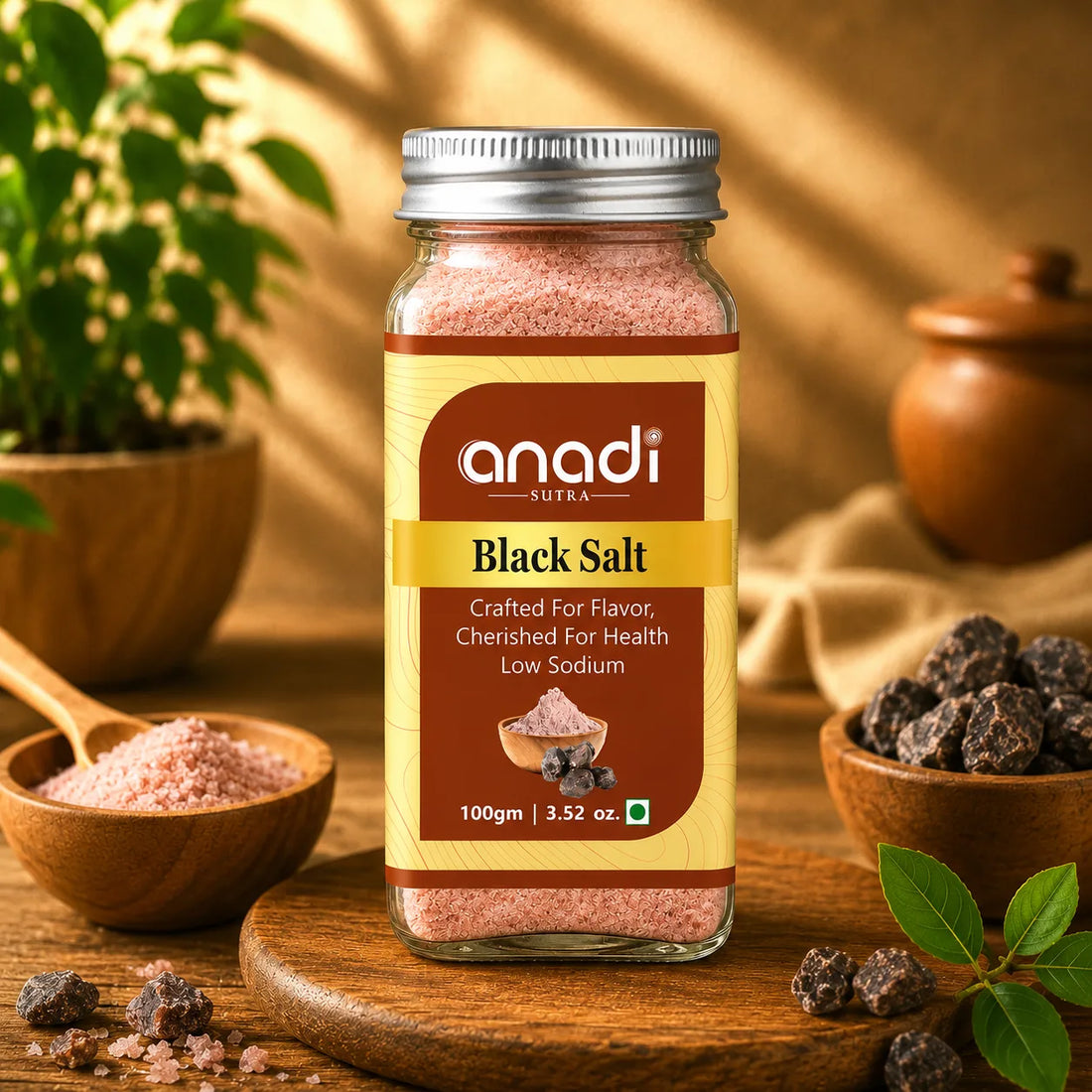 anadi SUTRA black salt jar, 100 g, with bowls of pink salt and dark salt rocks nearby