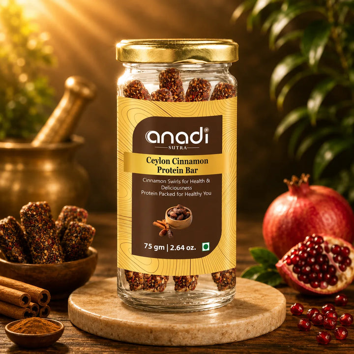 Close-up protein bar jar with gold lid on wooden base with cinnamon and pomegranate