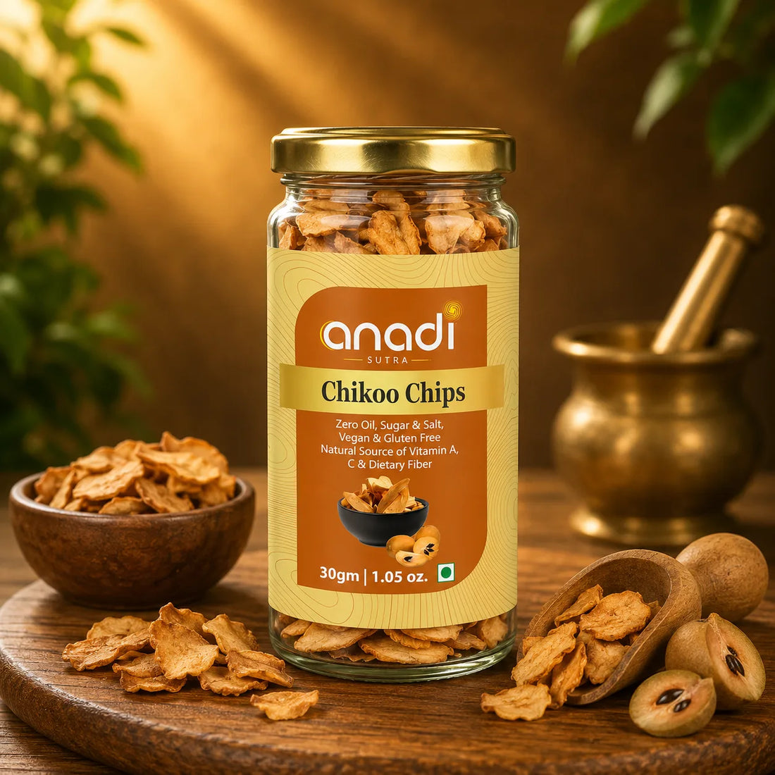 anadi Sutra Chikoo Chips jar with freeze-dried chips, 30 g, gold lid close-up