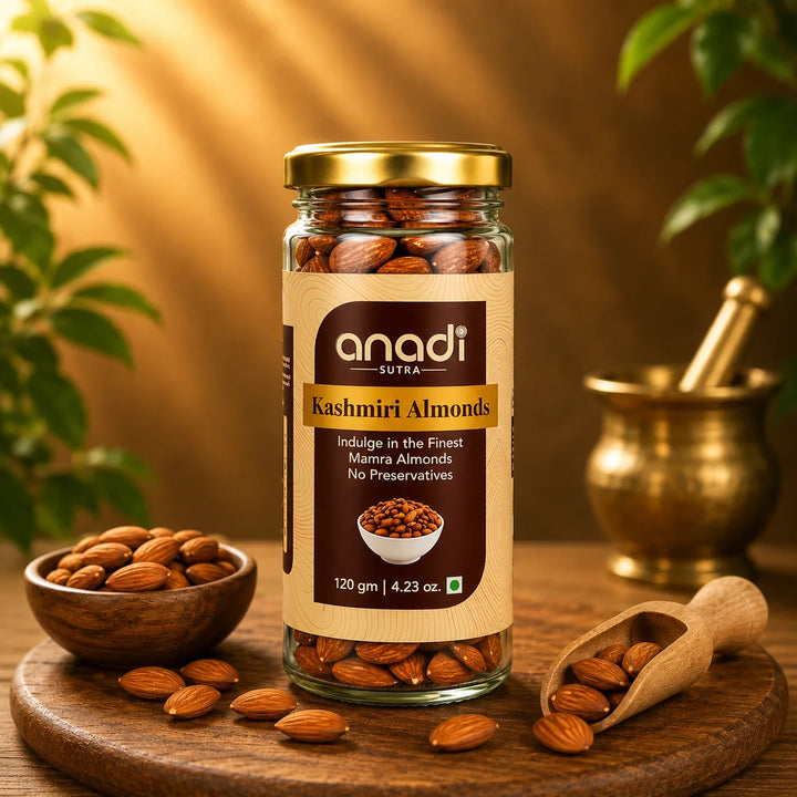 Glass jar of Kashmiri almonds with gold lid and wooden board of nuts