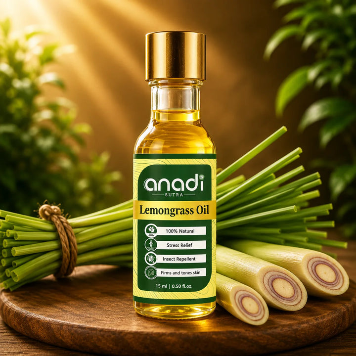 Amber lemongrass oil in 15 ml glass bottle with gold cap, with green stalks on a wooden base
