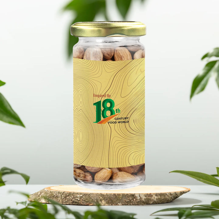 Nutmeg spice jar with gold cap, decorative front label with '18th' emblem