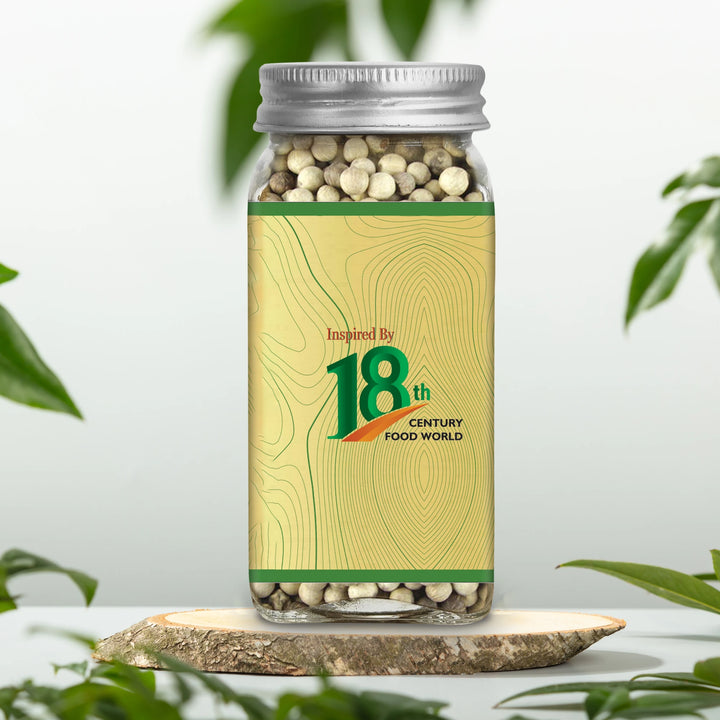 White pepper jar with 18th Century Food World label, silver lid, peppercorns