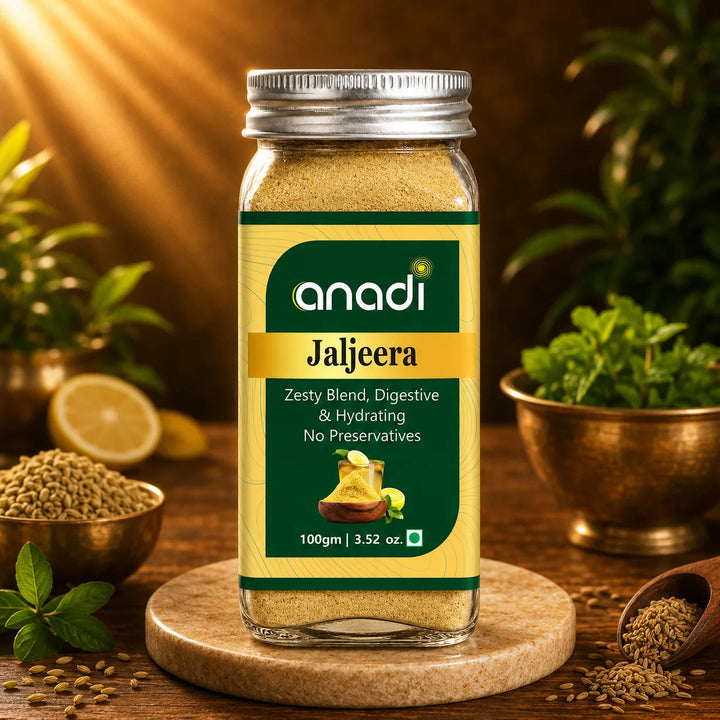 anadi Jaljeera bottle with silver screw cap on a round wooden base