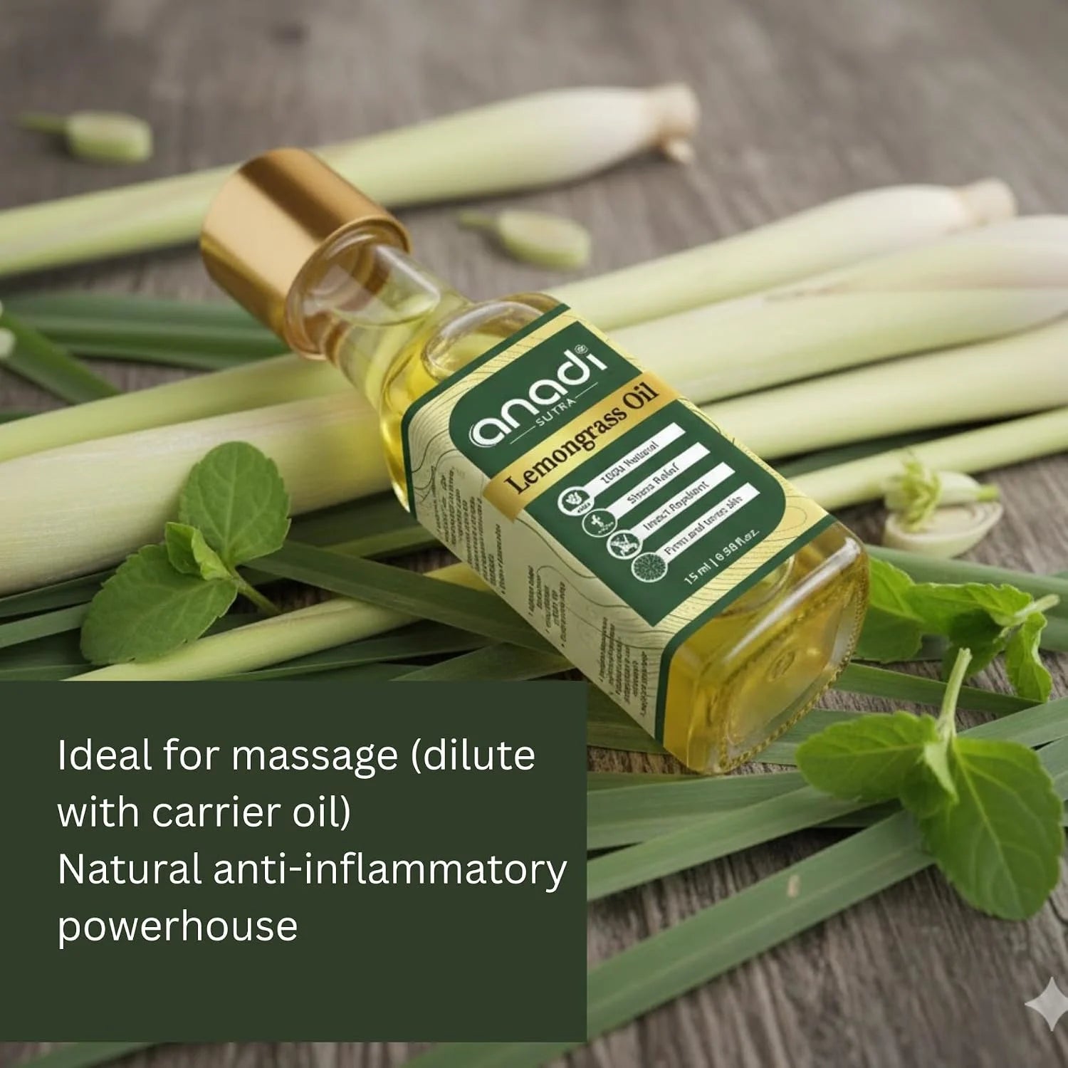 Glass lemongrass oil bottle with gold cap lying among green stalks and mint leaves