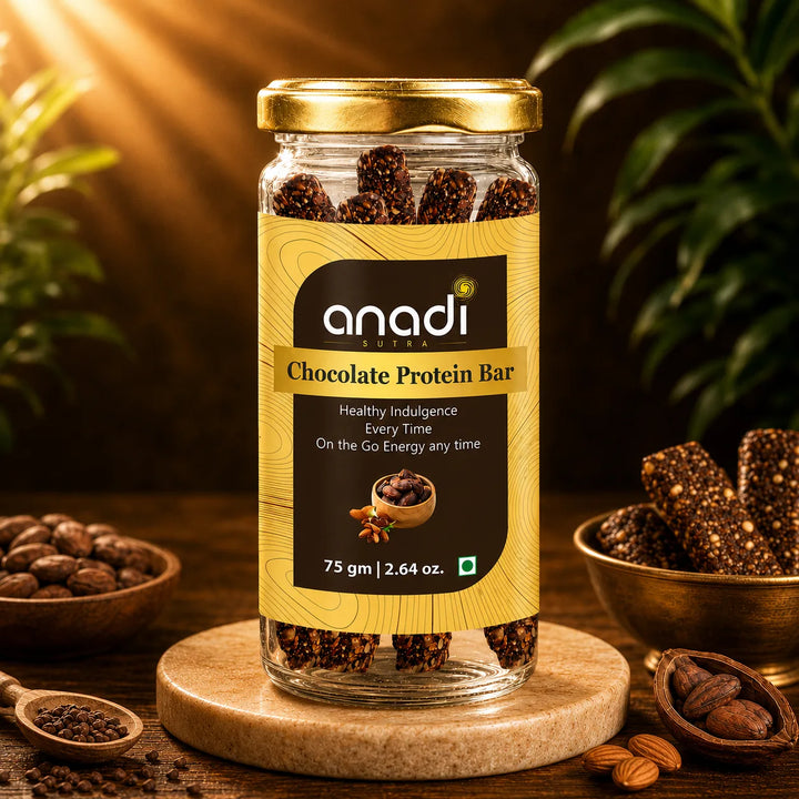anadi Chocolate Protein Bar in glass jar with gold lid, dark cocoa pieces visible