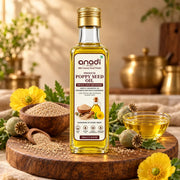 Poppy seed oil bottle with gold cap and clear glass containing golden oil