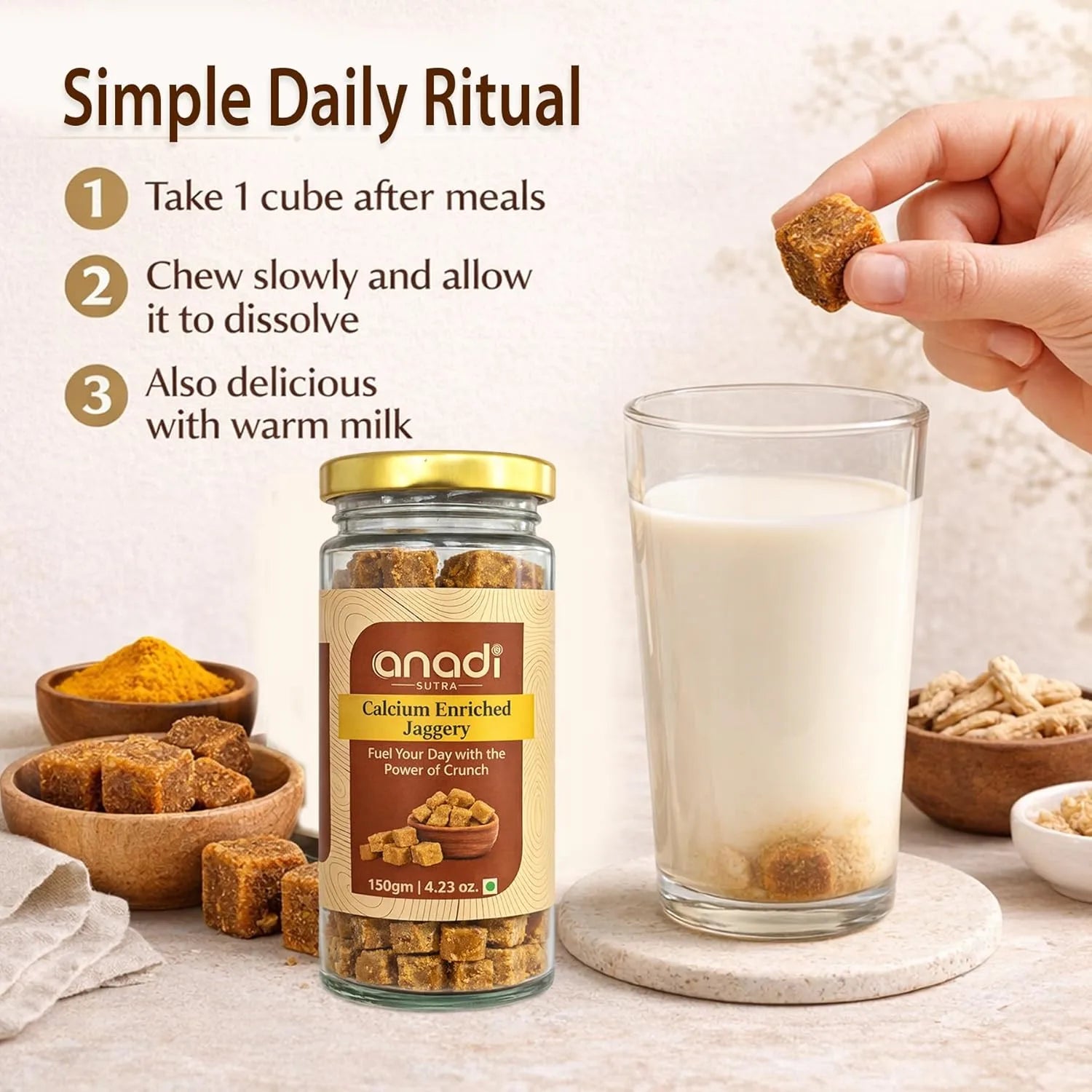 Calcium-enriched jaggery jar with gold lid, hand holding a brown cube near milk